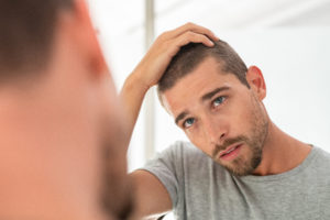Man concerned with hair loss.